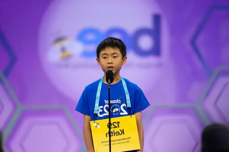 Boy participating in spelling bee competition.