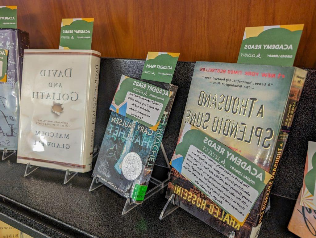Books on display with "Academy Reads" labels.